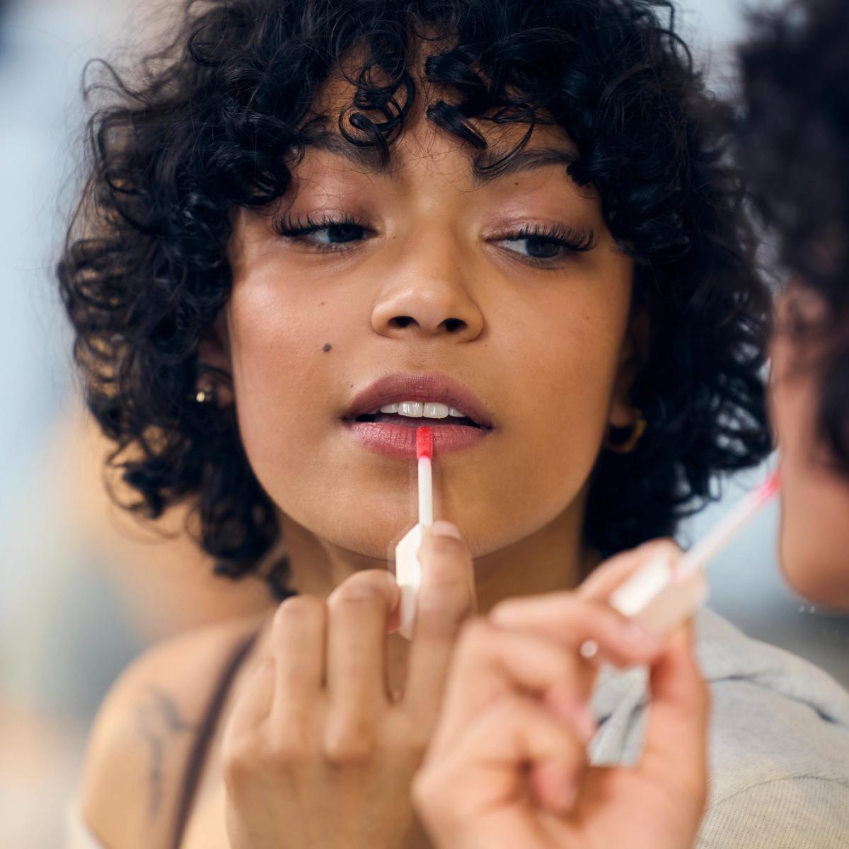 Woman applying lip product